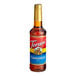 A Torani plastic bottle of cinnamon syrup with a red label.