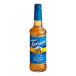A 750 mL plastic bottle of Torani sugar-free classic hazelnut syrup with a blue label.
