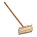 A Choice grill brush with a wooden handle.