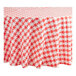 A red and white checkered Table Mate round plastic table cover on a table.