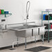 A Regency stainless steel 3 compartment sink with a left drainboard.