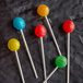 A group of paper lollipops on sticks with different colors.