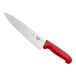 A Victorinox chef knife with a red handle.