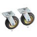 A pair of small black pneumatic wheels with metal plates.