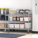 A Regency stainless steel mobile shelving unit with containers on it.