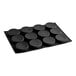 A black silicone baking tray with 12 circle cavities.