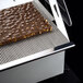 A chocolate bar on a Pavoni Lira dessert slicer tray.
