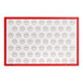 A white rectangular silicone baking mat with red circles.