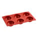 A red Pavoni silicone baking mold with six round compartments.