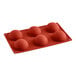 A red silicone mold with six round balls.
