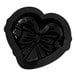 A black Pavoni silicone heart shaped baking mold with a bow on it.