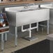 A Regency stainless steel underbar sink with left drainboard on a counter.