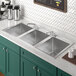 A stainless steel Regency drop-in sink with (2) faucets.