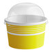 A yellow paper frozen yogurt cup with a white lid.
