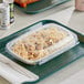 A white Inline Plastics rectangular plastic container with pasta and a fork.