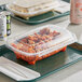 Two Inline Plastics Safe-T-Chef deli containers with pasta and meatballs on a tray.