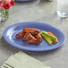 An Acopa purple melamine platter with chicken wings, celery, and carrots on it.