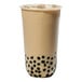 A Tossware rounded bottom plastic cup filled with bubble tea with black dots.