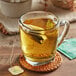 A glass mug of Harney & Sons Organic Peppermint Herbal Tea with a tea bag in it.