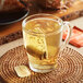 A glass mug of Harney & Sons Hot Cinnamon Spice tea with a tea bag in it.