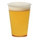 A Tossware Natural plastic cup filled with beer and foam on a white background.