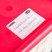 A red Cambro container with a StoreSafe label on it.