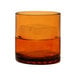 A Tossware Amber Tritan plastic rocks glass filled with a drink and ice.