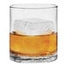 A Tossware Reserve Go-To plastic rocks glass filled with amber liquid and ice cubes.