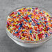 A bowl of Supernatural Rainbow Softies sprinkles in various colors.