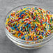 A bowl of Supernatural Rainbow Crunchies all-natural sprinkles in a variety of colors.