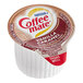A white and brown Coffee-Mate container with red and white text for Nestle Coffee-Mate Vanilla Caramel Single Serve Non-Dairy Creamer.