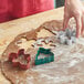 A person using Wilton holiday cookie cutters to make cookies.