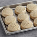 A tray of Otis Spunkmeyer preformed sugar cookie dough on a metal surface.