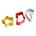 A group of Wilton metal holiday cookie cutters in red, yellow, and white shaped like a sock, star, and snowflake.