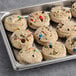 A tray of Otis Spunkmeyer Carnival cookie dough with colorful candies.