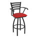 A black Holland Bar Stool Jackie Ladderback swivel bar stool with arms and a red vinyl seat.