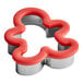 A Wilton metal gingerbread man cookie cutter with a red handle.