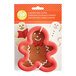 A package containing a Wilton metal gingerbread man cookie cutter.