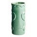 A close up of a green Acopa ceramic Tiki mug with a pattern.