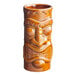 A close up of a brown Acopa Ceramic Tiki Mug with a face carved on it.