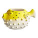 A yellow and white ceramic fish pot shaped like a puffer fish with black accents.