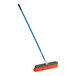 A Seymour Jobsite push broom with a long orange fiberglass handle.