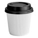 A white paper cup with a black lid.