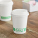 Two EcoChoice white compostable paper hot cups with a PLA lid.