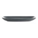 A grey rectangular stoneware platter with a speckled design on a counter.