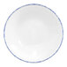 A white porcelain fruit bowl with a blue sponged rim.