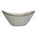 A white International Tableware stoneware soup bowl with brown specks.
