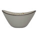 An International Tableware oval stoneware bowl with brown specks on a white background.