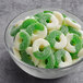 A bowl of green and white Albanese Green Apple Gummi Rings.