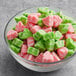 A bowl of green and pink Albanese Watermelon Gummi slices.